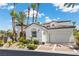 Beautiful home with a tile roof, arched details, mature palm trees, and a three-car garage at 11 Caminito Amore, Henderson, NV 89011