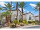 Stately home features a tile roof, arches, and tropical landscaping with palm trees in front yard at 11 Caminito Amore, Henderson, NV 89011