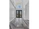 Spacious foyer features soaring ceilings, decorative double doors, and elegant wood-look floors at 11 Caminito Amore, Henderson, NV 89011