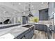 Modern kitchen features gray cabinetry, marble countertops, stainless steel appliances, and a large island at 11 Caminito Amore, Henderson, NV 89011