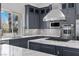 Gourmet kitchen featuring granite countertops, gray cabinetry, and stainless steel appliances at 11 Caminito Amore, Henderson, NV 89011