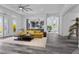 Bright living room with gray tile floors, arched doorways, and a comfortable yellow couch at 11 Caminito Amore, Henderson, NV 89011