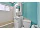 Bathroom featuring a toilet, sink, cabinet, tub and window at 1317 Pyramid Dr, Las Vegas, NV 89108