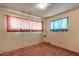 This bedroom has carpet, light colored walls, and curtains over the windows at 1317 Pyramid Dr, Las Vegas, NV 89108