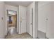 Hallway with tile floor, white walls, and multiple cabinets and closets at 1317 Pyramid Dr, Las Vegas, NV 89108