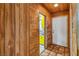 Hallway featuring wood paneling leading to the front door with an open view to the kitchen at 1317 Pyramid Dr, Las Vegas, NV 89108