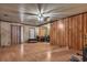 Large living area featuring wood-look laminate flooring, with both wood paneled and traditional painted walls at 1317 Pyramid Dr, Las Vegas, NV 89108