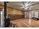 Spacious living room with wood-look laminate flooring, wood burning stove, and a ceiling fan at 1317 Pyramid Dr, Las Vegas, NV 89108
