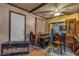 Living room featuring wood paneled walls, a ceiling fan, and a door leading outside at 1317 Pyramid Dr, Las Vegas, NV 89108