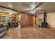 Open living area with wood-look laminate flooring, wood paneled walls, fireplace, and plenty of natural light at 1317 Pyramid Dr, Las Vegas, NV 89108