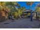 Backyard with a covered patio, a hanging bench, and a tropical aesthetic at 146 Cascade Dr, Henderson, NV 89074