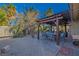 Relaxing backyard with covered patio, desert landscaping, and comfortable outdoor furniture at 146 Cascade Dr, Henderson, NV 89074