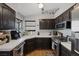 Kitchen features tile countertops, dark cabinets, and stainless steel appliances at 146 Cascade Dr, Henderson, NV 89074