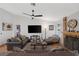 Comfortable living room featuring a brick fireplace, ceiling fan, and ample seating at 146 Cascade Dr, Henderson, NV 89074