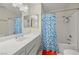 Bathroom boasting a shower-tub combo with a colorful blue shower curtain at 1513 Marita Dr, Boulder City, NV 89005