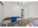 The bedroom includes carpet, a desk with a blue chair, and natural light at 1513 Marita Dr, Boulder City, NV 89005