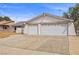 Home exterior displaying a two car garage with beautiful desert landscaping at 1513 Marita Dr, Boulder City, NV 89005