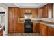 The kitchen includes wooden cabinets with granite countertops and a black range at 1513 Marita Dr, Boulder City, NV 89005