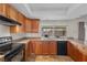 This kitchen features wooden cabinets, granite countertops, and stainless steel appliances at 1513 Marita Dr, Boulder City, NV 89005
