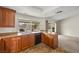 This kitchen features wooden cabinets, granite countertops, and stainless steel appliances at 1513 Marita Dr, Boulder City, NV 89005