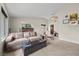 Comfortable living room featuring a cozy fireplace, large windows, carpet flooring, and neutral decor at 1513 Marita Dr, Boulder City, NV 89005