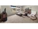 Inviting living room with a cozy fireplace, large windows, comfortable seating, and neutral carpet at 1513 Marita Dr, Boulder City, NV 89005