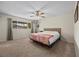 The main bedroom features carpet, a ceiling fan, and natural light from the window at 1513 Marita Dr, Boulder City, NV 89005