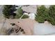 Aerial view of a home with mature trees, a driveway, and a large lot, surrounded by a fence at 1540 Labrador St, Pahrump, NV 89048