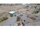 Aerial view of home with outbuildings, surrounded by desert landscape and ample space at 1540 Labrador St, Pahrump, NV 89048