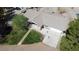 Aerial view of a home with a spacious driveway, mature trees, and a well-maintained lawn at 1540 Labrador St, Pahrump, NV 89048