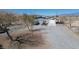 Aerial view of a property showcasing a garage, large outbuilding, and gravel landscaping at 1540 Labrador St, Pahrump, NV 89048