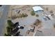Aerial view showing a large lot with vehicles, outbuildings and a house with a garage at 1540 Labrador St, Pahrump, NV 89048