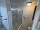 The bathroom features a glass shower enclosure with grab bars at 1540 Labrador St, Pahrump, NV 89048