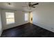 This bedroom features dark laminate flooring and dual windows for natural light at 1540 Labrador St, Pahrump, NV 89048