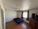 Bedroom includes hardwood floors, a ceiling fan, and a window providing natural light at 1540 Labrador St, Pahrump, NV 89048