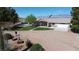Inviting home with lush lawn, mature trees, and a convenient driveway; great curb appeal at 1540 Labrador St, Pahrump, NV 89048