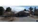 Single story home featuring a tile roof and covered patio area with table and chairs at 1540 Labrador St, Pahrump, NV 89048