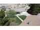 An attractive home with a well-manicured lawn and concrete driveway is seen from an aerial view at 1540 Labrador St, Pahrump, NV 89048