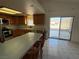Bright kitchen features wood cabinetry, a breakfast bar, and sliding glass doors to the backyard at 1540 Labrador St, Pahrump, NV 89048