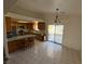 Open kitchen featuring wood cabinets, stainless steel appliances, tile floors, and backyard access at 1540 Labrador St, Pahrump, NV 89048