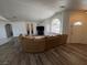 Open living room with hard wood floors and arched windows providing natural light at 1540 Labrador St, Pahrump, NV 89048