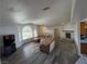 Bright living room features a fireplace, large windows, and an archway entrance at 1540 Labrador St, Pahrump, NV 89048