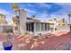 Enclosed sunroom with stone tile path and desert landscaping in the backyard at 1709 Autumn Rust Dr, Las Vegas, NV 89119