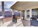 Outdoor patio with seating and grill, opening to a charming backyard landscape at 1709 Autumn Rust Dr, Las Vegas, NV 89119