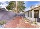 Spacious backyard featuring desert landscaping, a covered patio, and block wall fencing at 1709 Autumn Rust Dr, Las Vegas, NV 89119