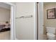 Neutral-toned bathroom featuring a toilet, towel bar, and bathroom-themed artwork at 1709 Autumn Rust Dr, Las Vegas, NV 89119