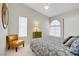 Bright bedroom featuring a window with blinds, chair and comfortable furnishings at 1709 Autumn Rust Dr, Las Vegas, NV 89119