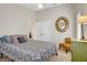 Cozy bedroom with high ceilings, a ceiling fan, and a decorative round mirror at 1709 Autumn Rust Dr, Las Vegas, NV 89119