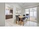 Bright dining area with tile floors, access to the sunroom, and an open view to the kitchen at 1709 Autumn Rust Dr, Las Vegas, NV 89119