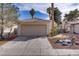 Charming single-story home featuring a two-car garage and desert landscaping at 1709 Autumn Rust Dr, Las Vegas, NV 89119